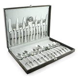 Polished stainless steel cutlery set neatly arranged in a sleek black presentation box with white interior.